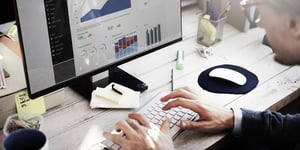 Analytics consultant working at a computer