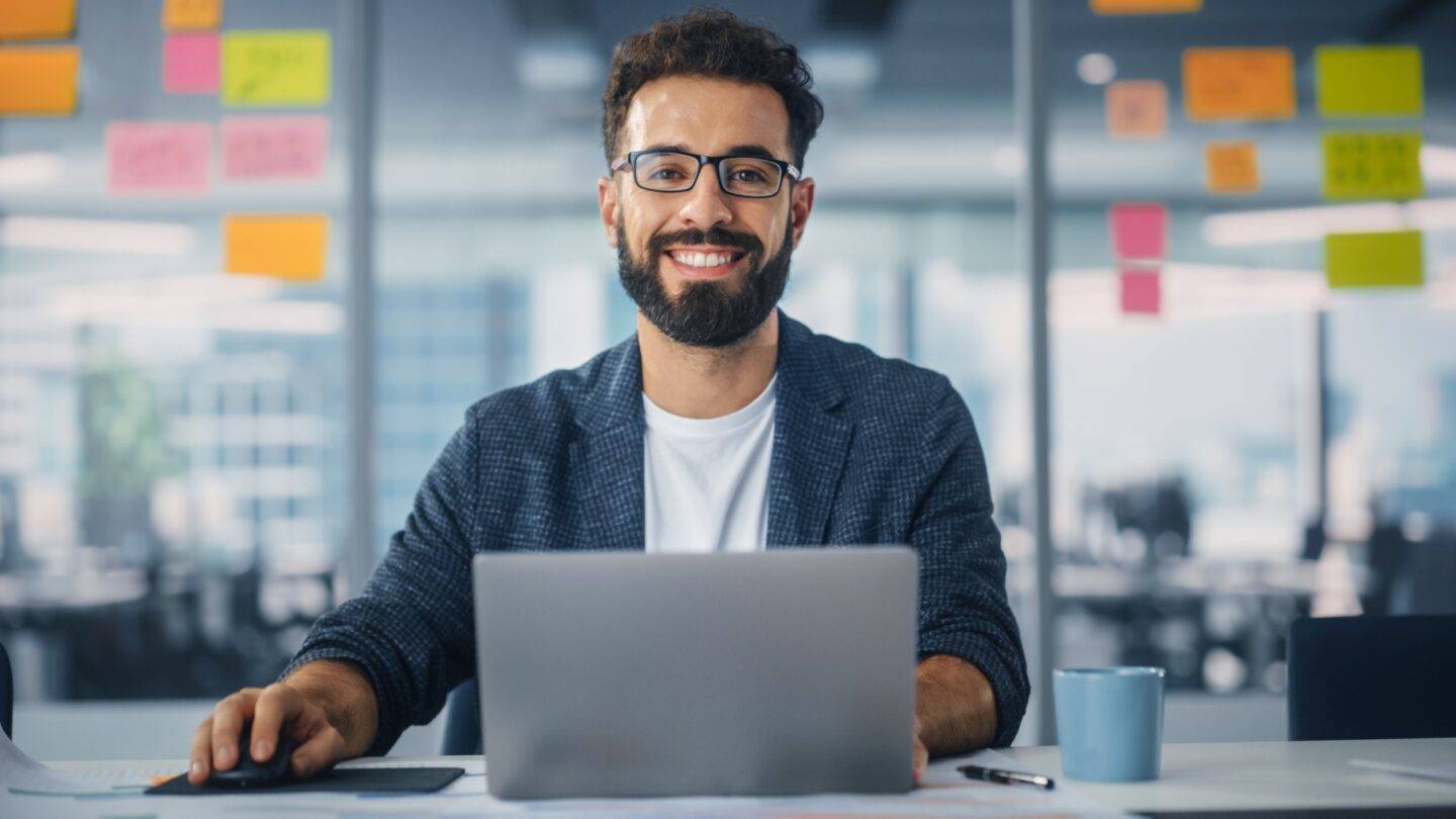 Smiling male working professional working in an office
